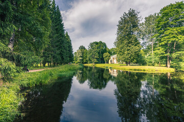 A peaceful scene of a river with a house in the background