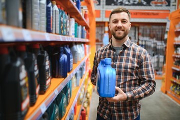 man buys automobile chemicals in the auto parts store