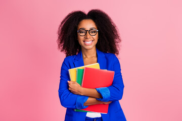 Photo of positive lovely woman wear trendy blue clothes hold copybooks isolated on pink color background