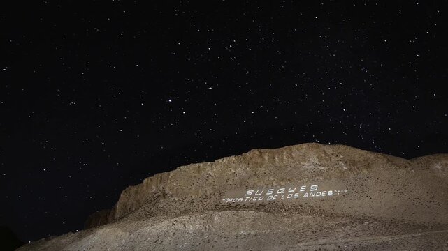 Sign in Rocks Saying "Susques, Portico of the Andes" on a Hill with a Starry Sky in Jujuy, Argentina