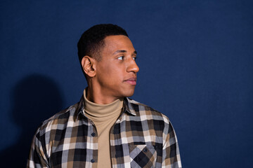 Obraz premium Photo portrait of nice young man look empty space wear trendy plaid outfit isolated on dark blue color background
