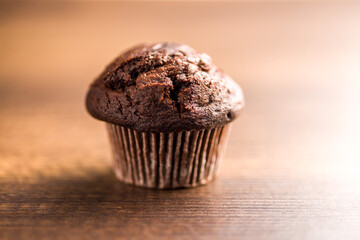 Sweet muffin cakes on wooden table.