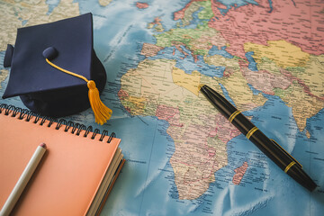 Graduation cap on world map, study abroad concept, global education, international student journey, higher studies, university degree, travel learning, academic success, career opportunities