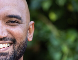 Smiling man with beard enjoying outdoor lifestyle, close-up of face, copy space