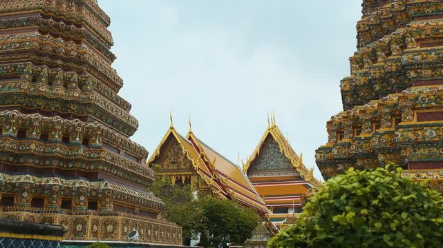Colorful intricately decorated pagodas and traditional Thai temple complex Wat Pho with golden ornaments and detailed carvings in Bangkok city with Buddhist architecture in Thailand, Asia