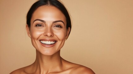 Cheerful georgeous caucasian middle aged woman with perfect radiant skin and open shoulders smiling with toothy smile against neutral studio backgrounf