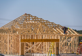 Single family home with slab foundations and dimensional lumber frames and roof trusses creating the structure of the house