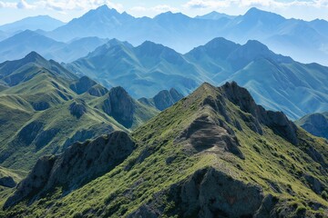 Obraz premium Breathtaking panoramic view of rugged mountain ranges under a clear sky in the early afternoon light