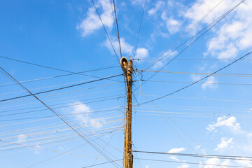 street lamp pole with many tangled electrical wire