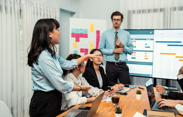 Project manager planning schedules for business task at meeting room, Gantt chart software show on...