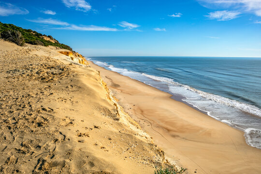 View of Cuesta de Maneli beach on the coast of Huelva, Andalusia, Spain, on a sunny day and golden sands