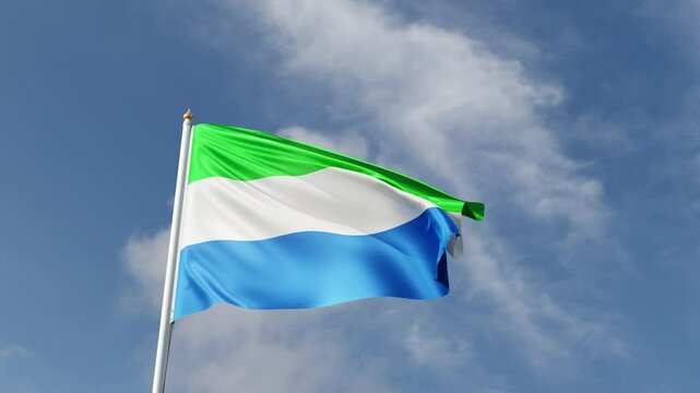 Flag of sierra leone on a blue sky, flag on a flag pole waving in the wind, african country, national symbol of sierra leone, video of a flag	