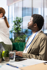 Advisory board members and team leaders gathering to review project outcomes, discuss resource allocation to ensure objectives achievement. Diverse business associates in a meeting.