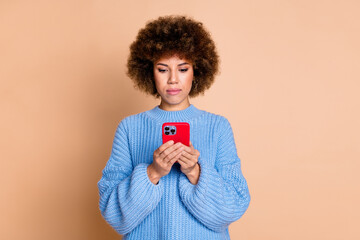 Photo of smart focused serious girl dressed blue knitwear sweater look at smartphone read email isolated on pastel color background