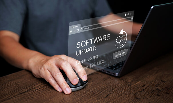 Software update concept. Man working and Installing business program updates on computer for better performance, security and new features