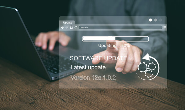 Software update concept. Man updating and Installing business program updates on computer for better performance, security and new features