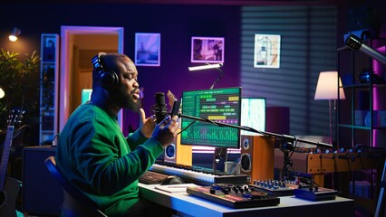 Male composer recording his melody on microphone in home studio, singing a song of his own creation. Talented artist using audio files and lyrics to apply mixing and mastering techniques. Camera B.