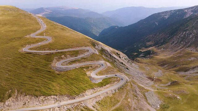 Aerial view of the Carpathian Mountains in Romania. Transalpina. Drone video of one of the most iconic roads in Romania called Transalpina Road. Parang mountains. Top cinematic aerial view