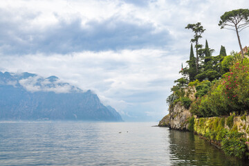 Lake Garda with mountains in background, view from Malcesine town on the eastern shore of the lake, Italy, Europe.