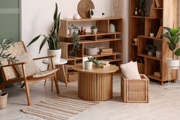 Interior of living room with armchair, plants and shelf units