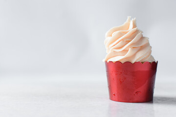 red cupcakes with tall pink buttercream swirl, cupcakes in red foil liners with pink buttercream, frosted cupcakes on a white background