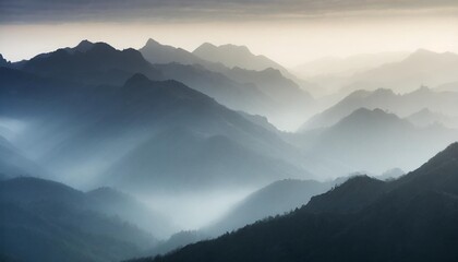 Fototapeta premium Misty Mountains at Dawn, Shrouded in Fog and Illuminated by Soft Light
