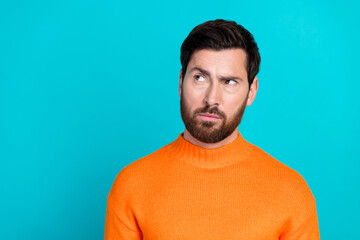 Fototapeta premium Photo of handsome minded man wear orange trendy clothes look empty space isolated on cyan color background