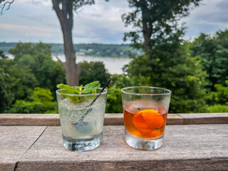 Two Drinks On Ledge Looking At River