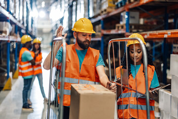 Warehouse inspection: focused workers checking inventory boxes