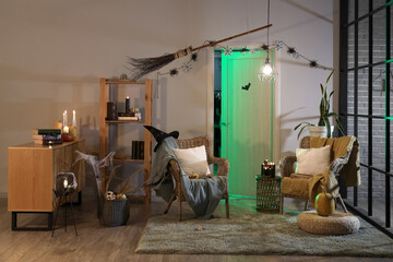 Interior of festive living room with armchairs and Halloween decorations in evening