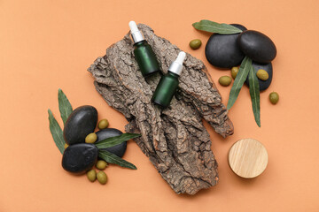 Composition with natural cosmetic products, tree bark, spa stones and green olives on color background