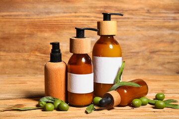 Set of natural cosmetic products and green olives on wooden background