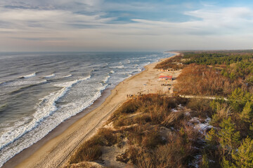 Aerial view of the Baltic Sea shore line near Klaipeda city, Lithuania. Beautiful sea coast on chilly and snowy winter day.