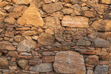 Stone wall on an old building in a village in Rajasthan.