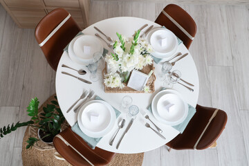 Table setting with white Gladiolus flowers in room, top view