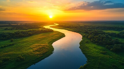 Fototapeta premium Birds-eye view of lush farmland, golden wheat fields beside a winding river, soft glow of sunrise, photorealistic, vivid colors, vibrant sky
