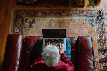 Senior woman sitting on sofa using laptop work and study or Online medical consultations. at home. Medical Consultation.