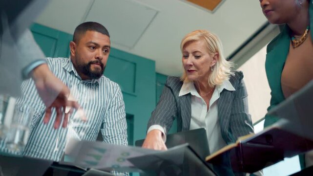 Discussion, group and meeting in boardroom, ideas and documents for financial report or brainstorming. Low angle, talk and ai for fraud detection of insurance and processing of claims, plan or people