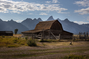 Photograph of the Moulton Barn on a mormon homestead abandoned in the middle of open prairie flanked by the Teton Mountains at Mormon Row, near Jackson, Wyoming.