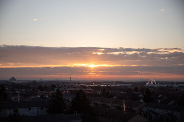 Sunrise over the roofs of the city. It is a beautiful winter landscape. Canada.	