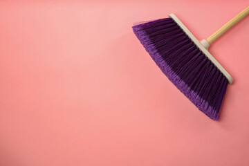 One cleaning broom on pink background, top view. Space for text