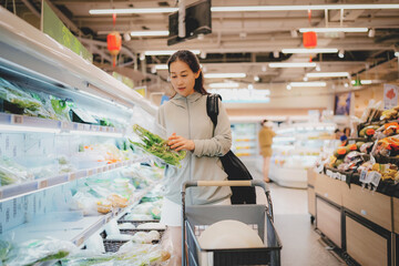 Young Woman Shopping for Fresh Vegetables in a Supermarket