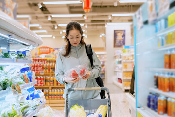 Young Woman Enjoying Healthy Grocery Shopping Experience in Modern Supermarket