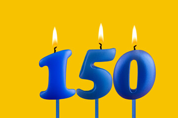 Blue birthday candle on yellow background - Number 150