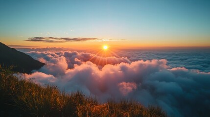 Fototapeta premium 60. 4K timelapse footage of a majestic sunrise viewed from a high mountain, showing the sun rising from the horizon, creating a stunning display of golden light on the clouds against a blue sky