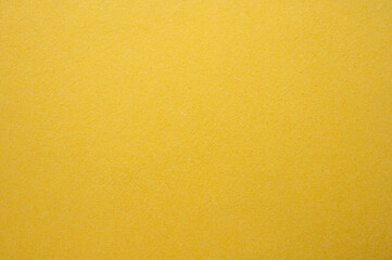 Full frame shot of yellow paper sheet texture and background. Colored paper or construction paper,...