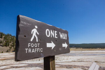 Photo of one way foot traffic wooden sign located at the mid way basin Yellowstone National Park in Wyoming 