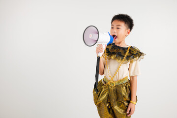 Portrait Thailand kid boy smiling traditional Thai dress costume shouting by megaphone, studio shot...