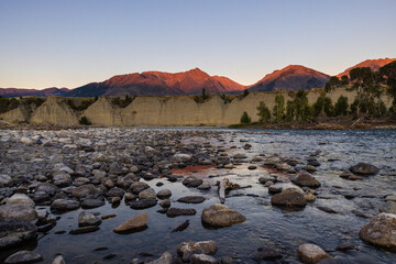 Sunset photo of Yellowstone river rocky shoreline surface in Livingstone Montana.