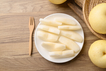 Asian pear fruit on plate ready to eating, Sweet and juicy fruit, Table top view
